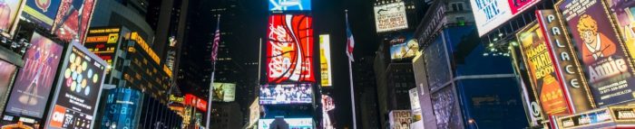 Manhattan banner Times Square at night. Image via Wikipedia by chensiyuan. CC BY-SA 3.0