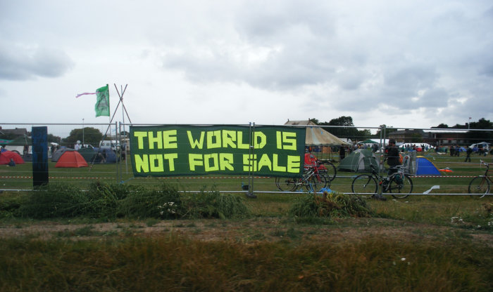 A banner on the fence erected around the Camp for Climate Action at Blackheath in August 2009. Image via Flickr by SallyB. CC BY 2.0